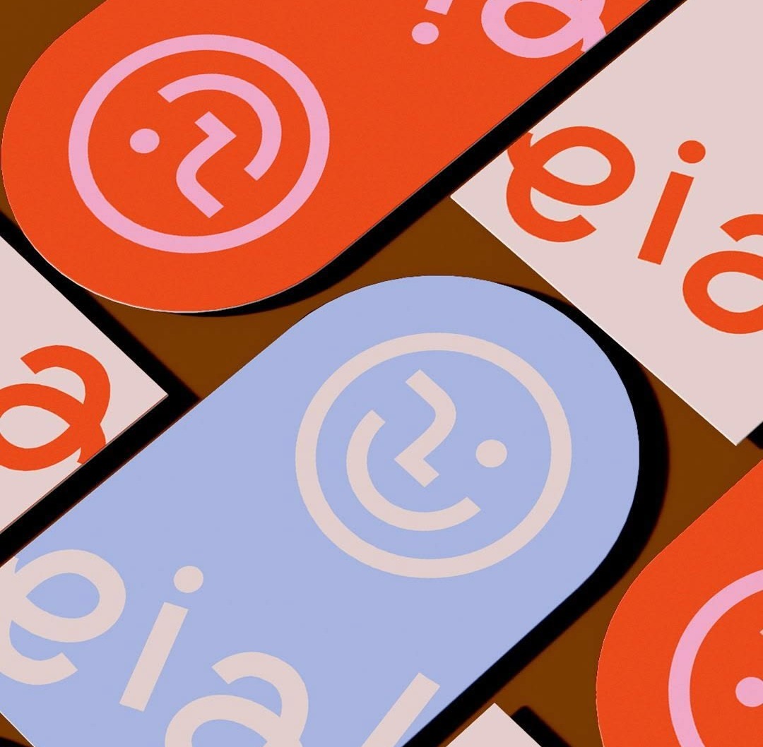 Pill-shaped eia stickers with a smiley made of a question mark