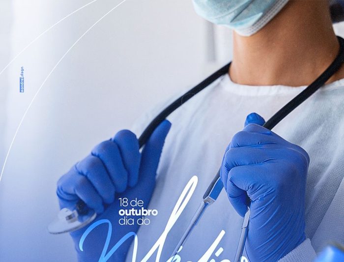 A clinician in mask, blue gloves and scrubs