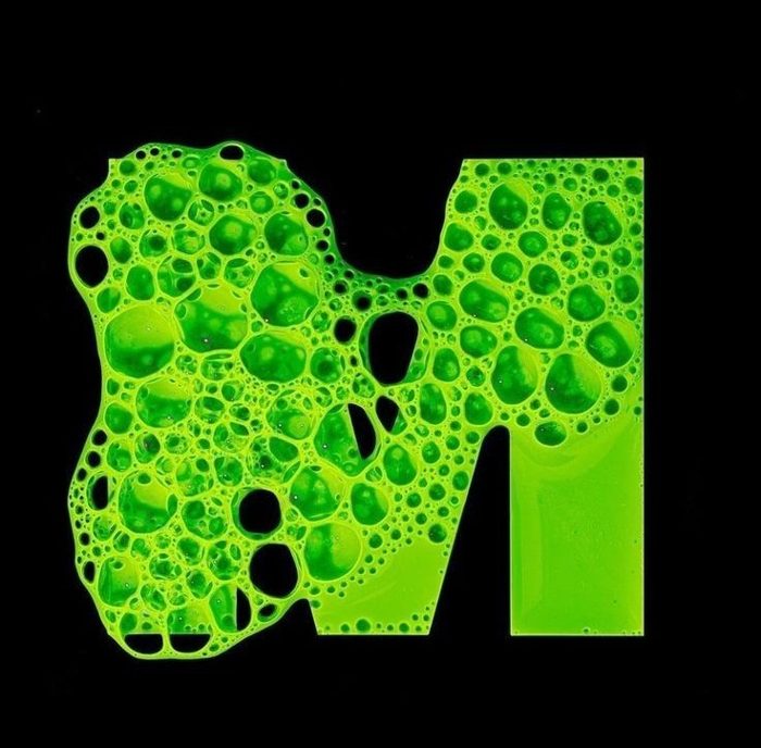 Green foam letterform on black