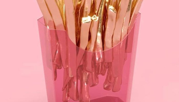 Gold forks cast in a pink resin block