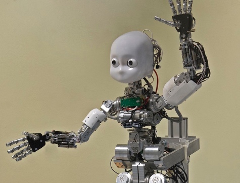 iCub robot with a child-like face and raised hand
