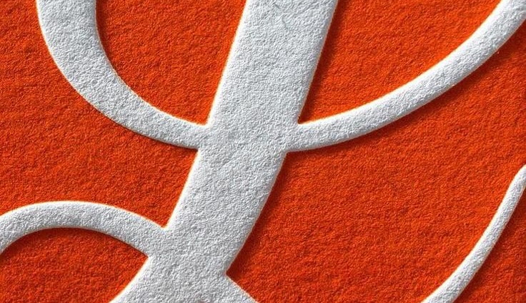 A white ampersand on orange felt
