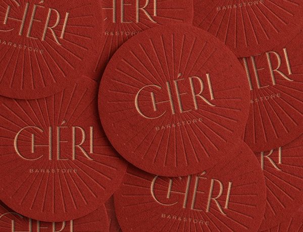 Red letterpressed Cheri coasters with an Art Deco lockup