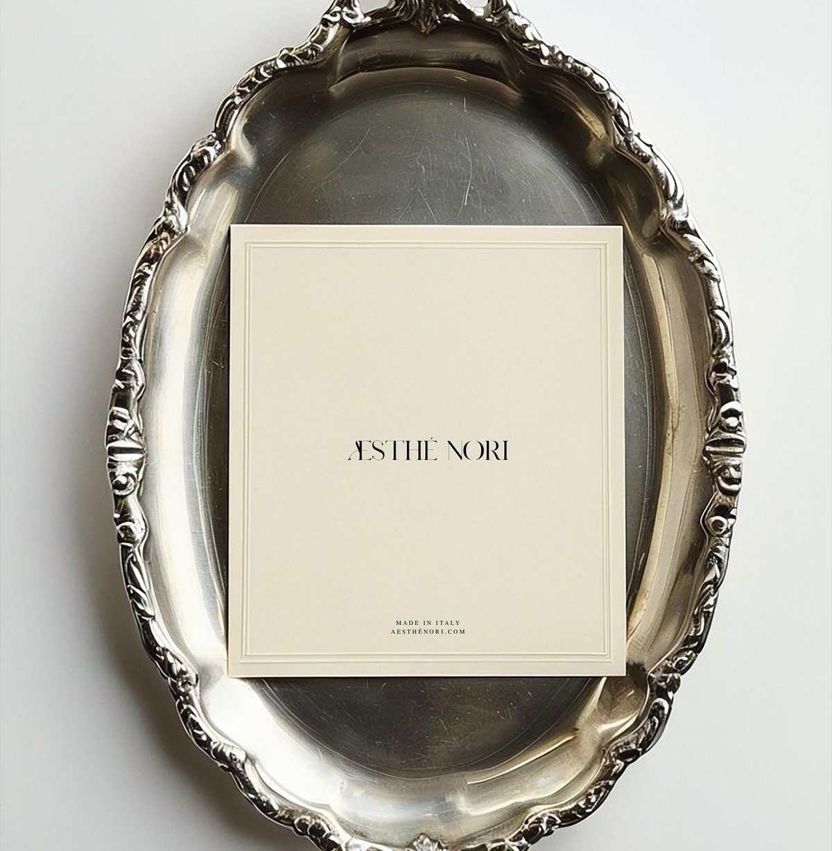 Aesthe Nori cream card resting on a baroque silver tray
