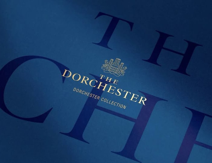 The Dorchester gold serif lockup on navy