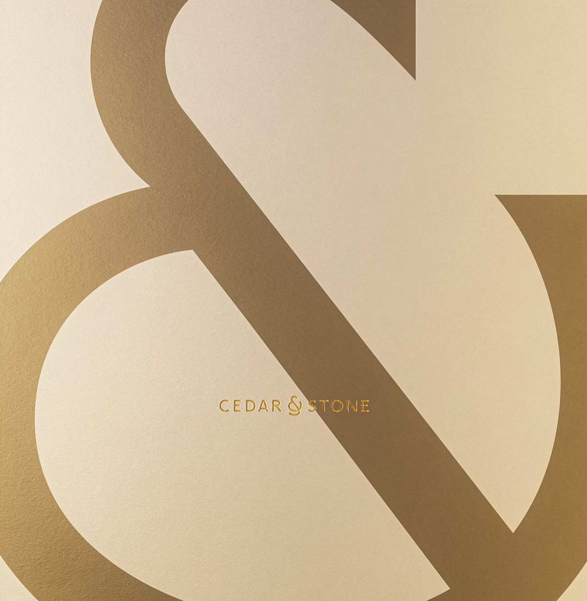 Cedar and Stone modern geometric ampersand in gold on cream