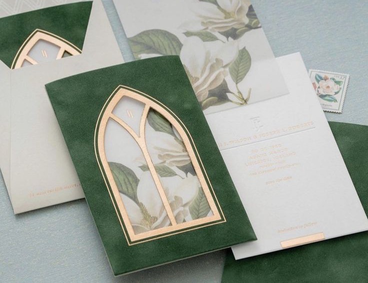 Green wedding stationery with a gold cutout arched window