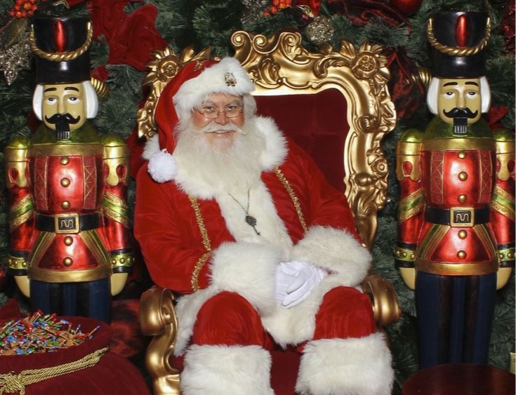 Santa on a gold throne flanked by nutcrackers